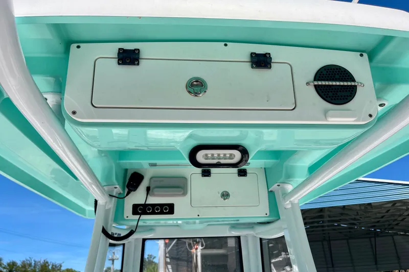 Slide: The Image of Interior view of a 2022 Blue Wave 2800 Pure Hybrid boat console with storage compartments. - 17