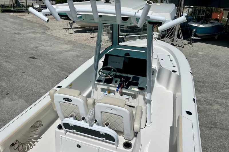 Slide: The Image of 2022 Blue Wave 2800 Pure Hybrid boat interior with steering console and seating. - 13