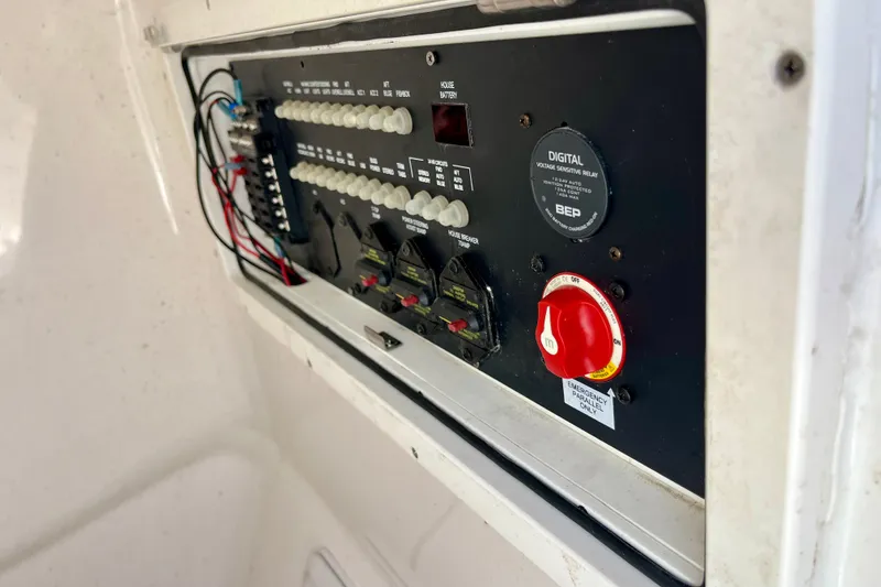 Slide: The Image of Electrical panel of 2022 Blue Wave 2800 Pure Hybrid boat, featuring switches and wiring. - 28