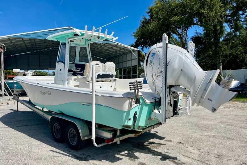 Slide: The Image of 2022 Blue Wave 2800 Pure Hybrid boat on trailer, featuring Yamaha outboard motor. - 8