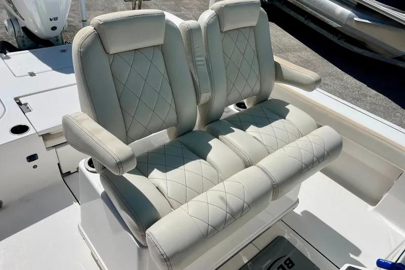 Slide: The Image of Luxury seating on 2022 Blue Wave 2800 Pure Hybrid boat, featuring diamond-stitched upholstery. - 14