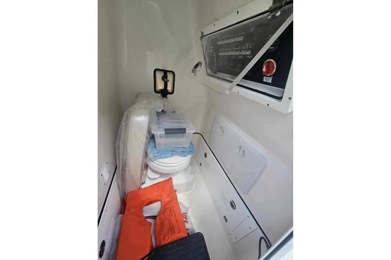 Slide: The Image of 2022 Blue Wave 2800 Pure Hybrid boat interior with storage and safety equipment. - 5