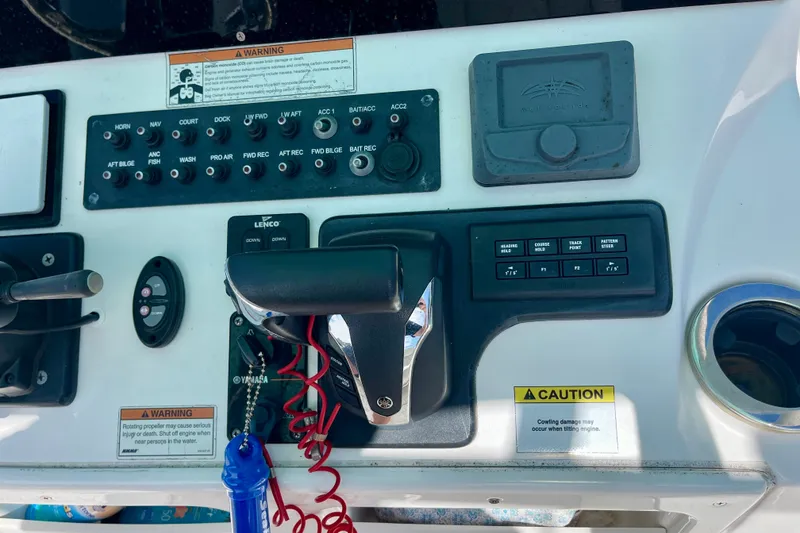 Slide: The Image of Control panel of a 2022 Blue Wave 2800 Pure Hybrid boat with various switches and warnings. - 19