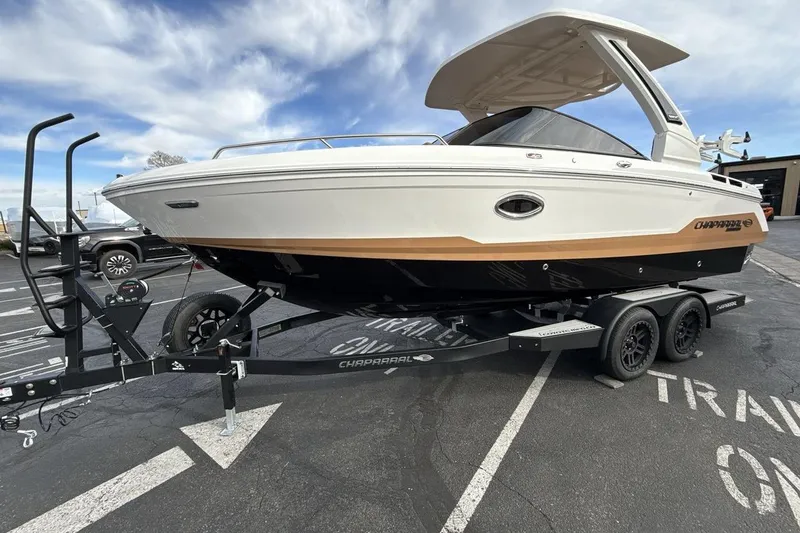 The Image of 2026 Chaparral GTS 6 boat on trailer, parked outdoors under blue sky. - 1