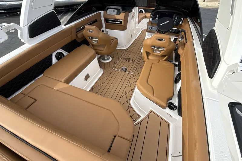 Slide: The Image of 2026 Chaparral GTS 6 boat interior with tan leather seating and modern dashboard. - 10