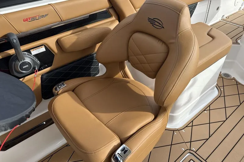 Slide: The Image of Luxurious tan seating in 2026 Chaparral GTS 6 boat interior, featuring sleek design and comfort. - 13