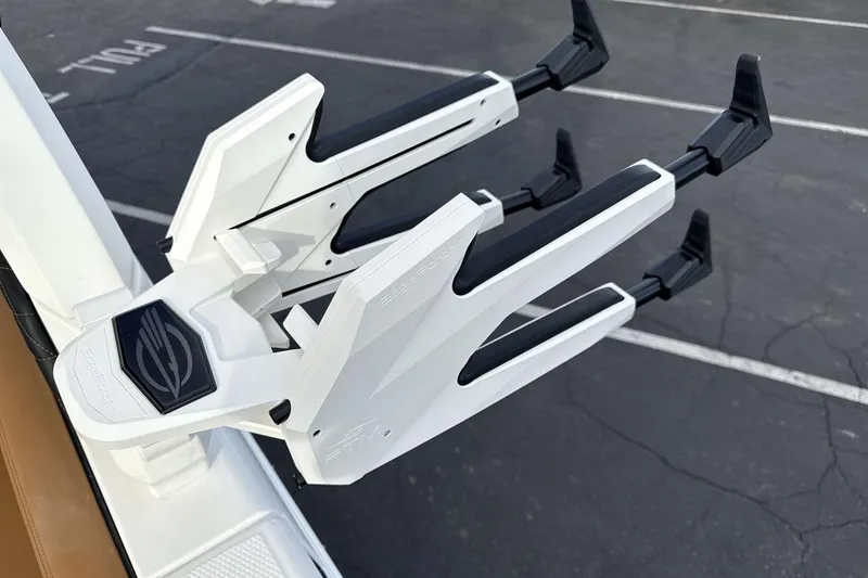 Slide: The Image of 2026 Chaparral GTS 6 boat accessory, sleek white design with black accents, parked on asphalt. - 21