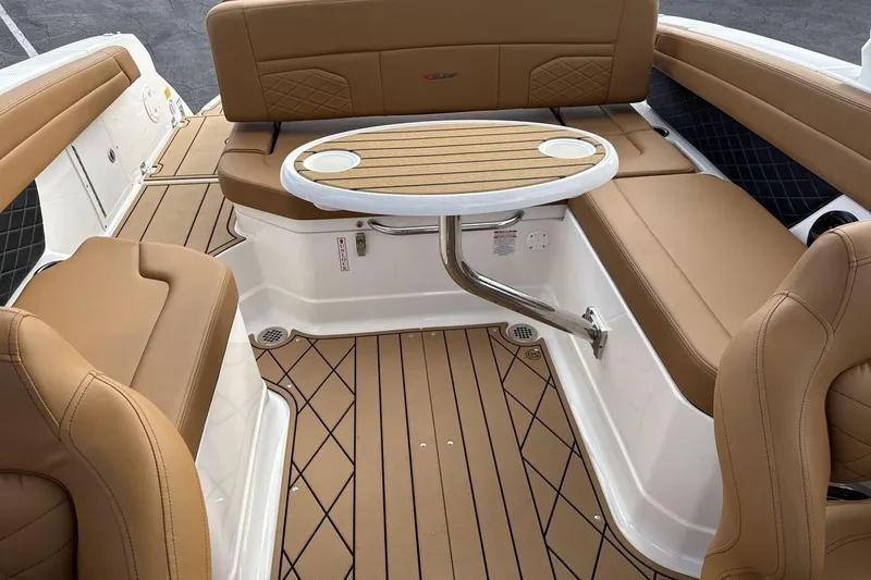 Slide: The Image of 2026 Chaparral GTS 6 boat interior with tan seating and a round table. - 22