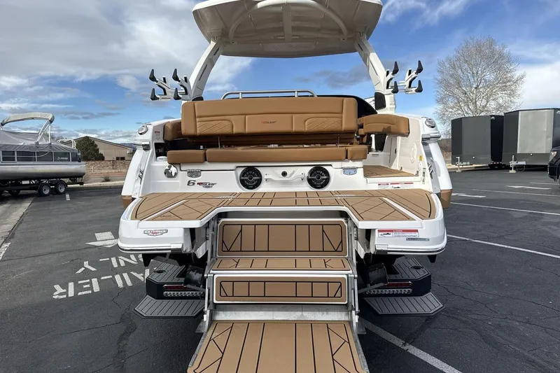 Slide: The Image of 2026 Chaparral GTS 6 boat rear view with tan seating and swim platform. - 4