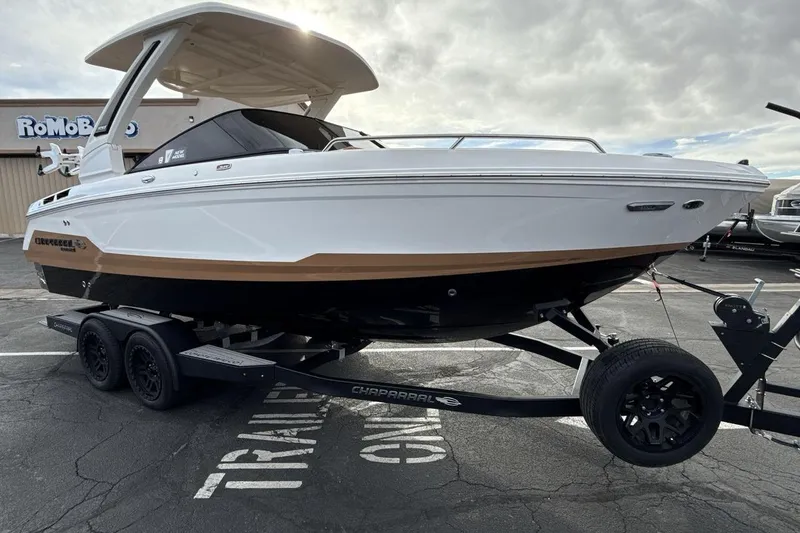 Slide: The Image of 2026 Chaparral GTS 6 boat on trailer, parked outdoors under cloudy sky. - 7