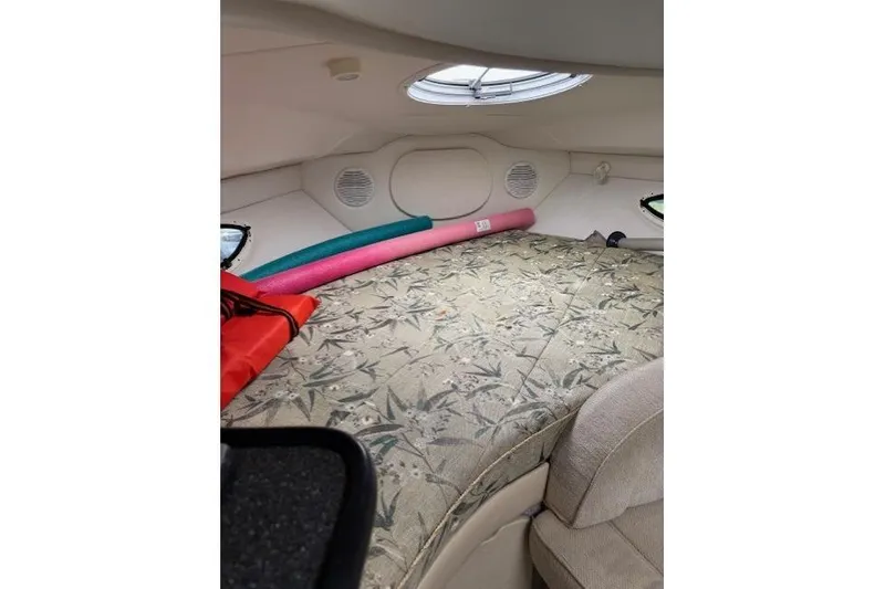 Slide: The Image of Interior cabin of 2001 Maxum 2900 SCR boat with floral-patterned bedding. - 10