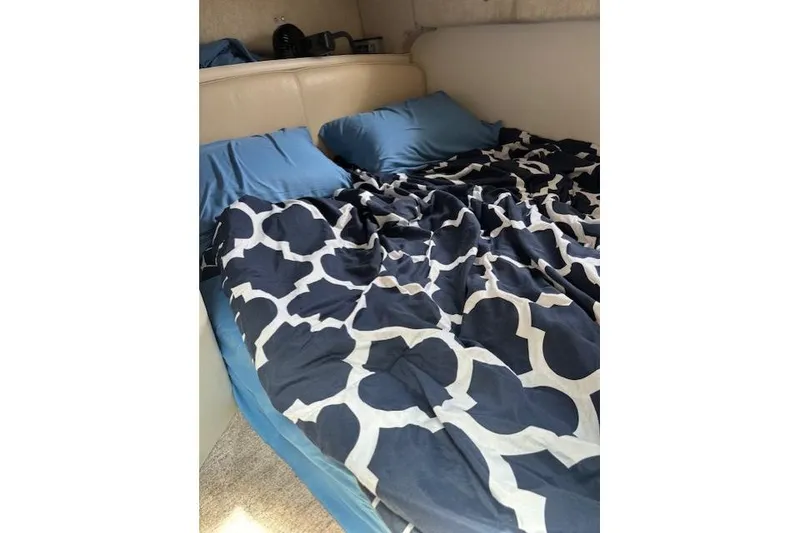 Slide: The Image of Interior of 2001 Maxum 2900 SCR boat with cozy bed and patterned bedding. - 12