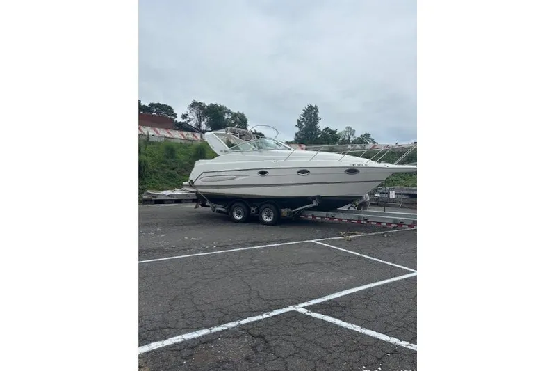 Slide: The Image of 2001 Maxum 2900 SCR boat on trailer in parking lot. - 14