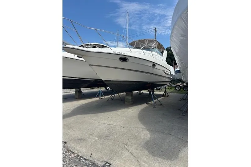 Slide: The Image of 2001 Maxum 2900 SCR boat on trailer, rear view, overcast sky. - 2