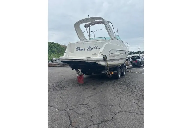 Slide: The Image of 2001 Maxum 2900 SCR boat on trailer, parked on asphalt. - 3
