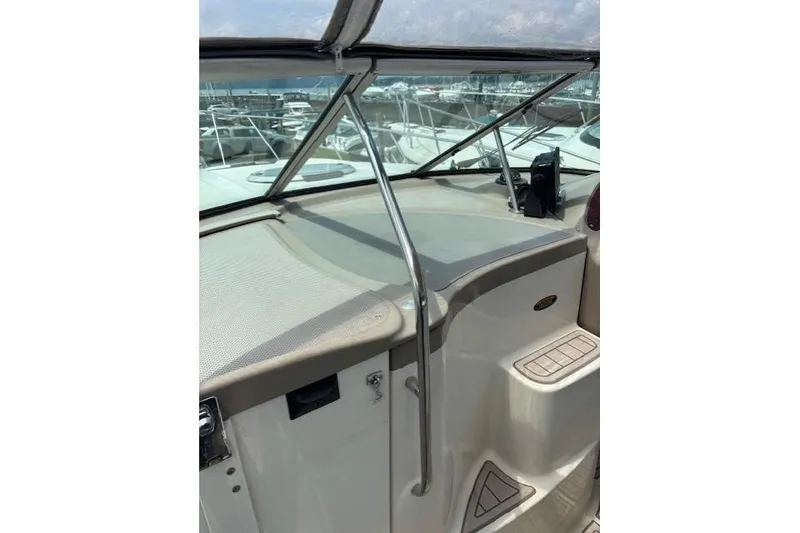 Slide: The Image of 2001 Maxum 2900 SCR boat dashboard with windshield and marina view. - 5
