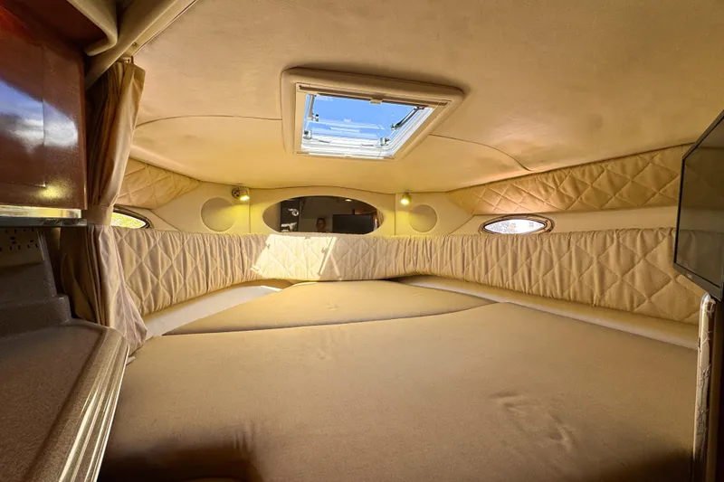 Slide: The Image of Interior cabin of 2006 Sea Ray 290 Amberjack with beige upholstery and skylight. - 17