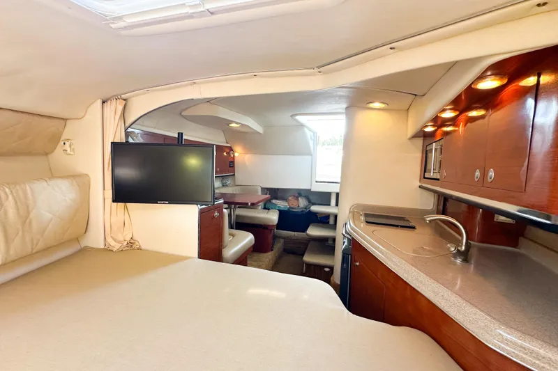 Slide: The Image of Interior of 2006 Sea Ray 290 Amberjack with kitchenette, seating, and TV. - 18