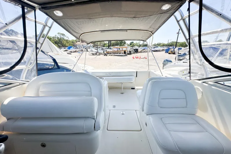 Slide: The Image of 2006 Sea Ray 290 Amberjack boat interior with white seating and canopy. - 22