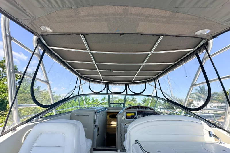 Slide: The Image of 2006 Sea Ray 290 Amberjack boat interior with canopy and dashboard view. - 23