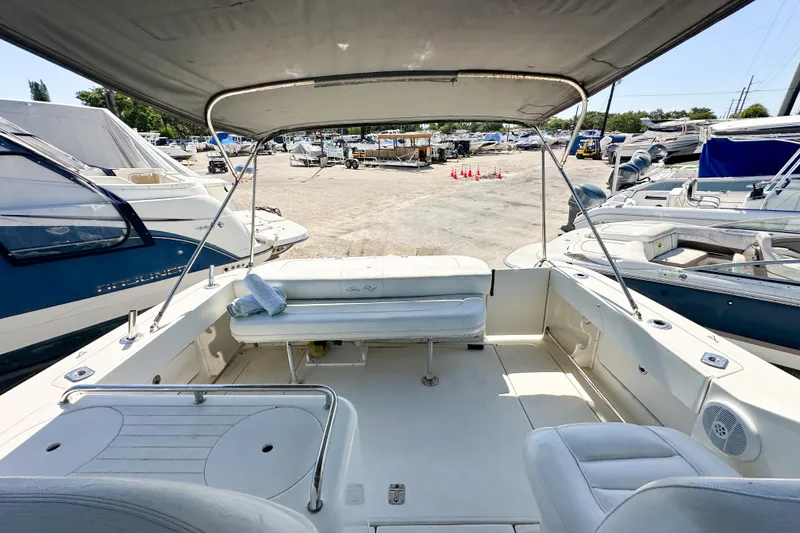 Slide: The Image of 2006 Sea Ray 290 Amberjack boat interior with seating, docked at a marina. - 24