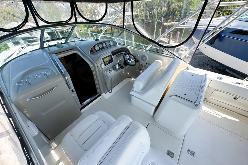 Slide: The Image of 2006 Sea Ray 290 Amberjack cockpit with helm, seating, and dashboard controls. - 27
