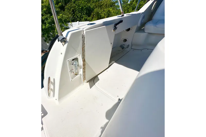 Slide: The Image of 2006 Sea Ray 290 Amberjack boat interior with white seating and control panel. - 3