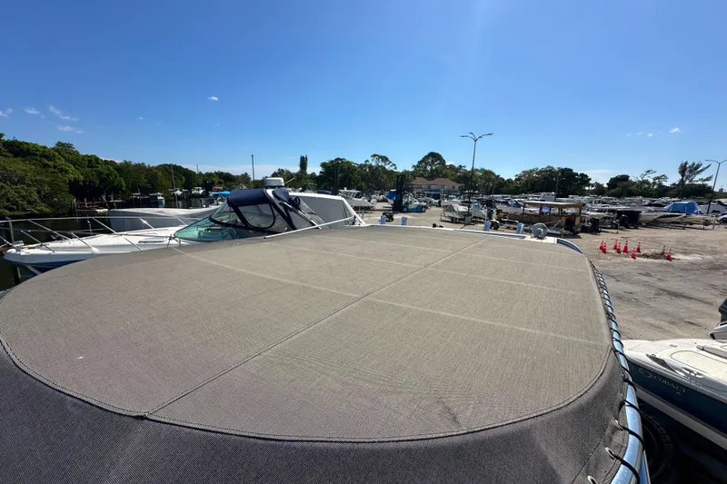 Slide: The Image of 2006 Sea Ray 290 Amberjack boat docked at marina under clear blue sky. - 32