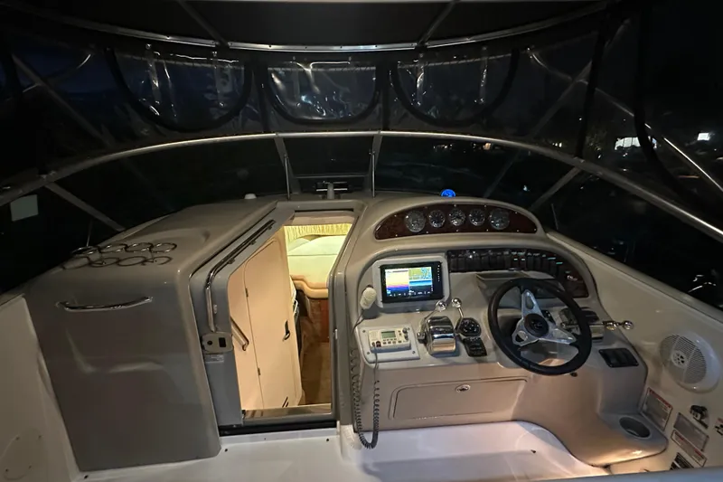 Slide: The Image of 2006 Sea Ray 290 Amberjack cockpit with navigation equipment and cabin entrance. - 42