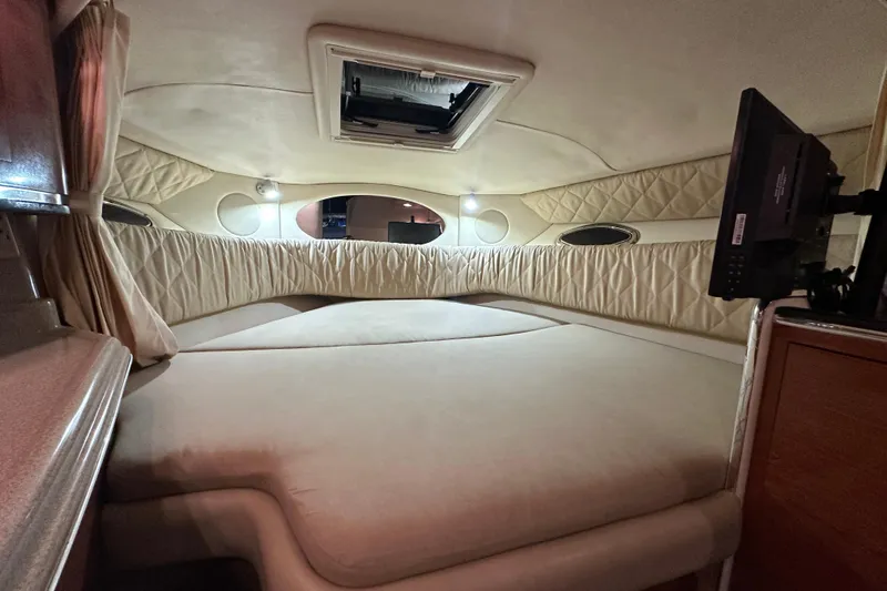 Slide: The Image of Cozy cabin interior of 2006 Sea Ray 290 Amberjack with bed and TV. - 44