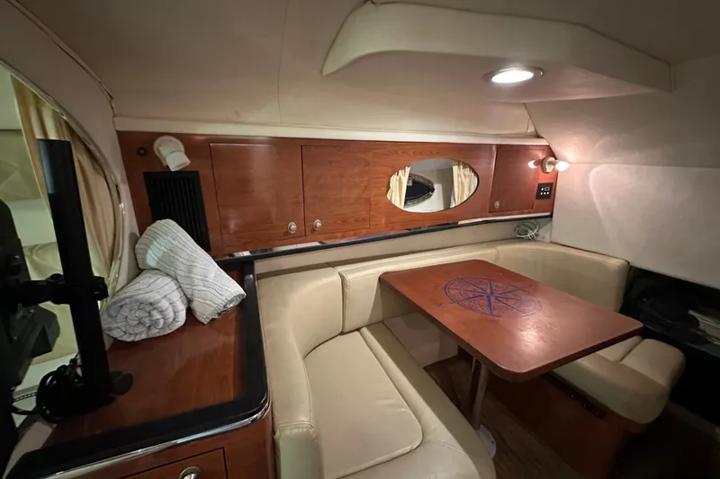 Slide: The Image of Interior of 2006 Sea Ray 290 Amberjack with cozy seating and wooden table. - 45