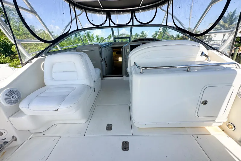 Slide: The Image of 2006 Sea Ray 290 Amberjack boat interior with white seating and clear canopy. - 6