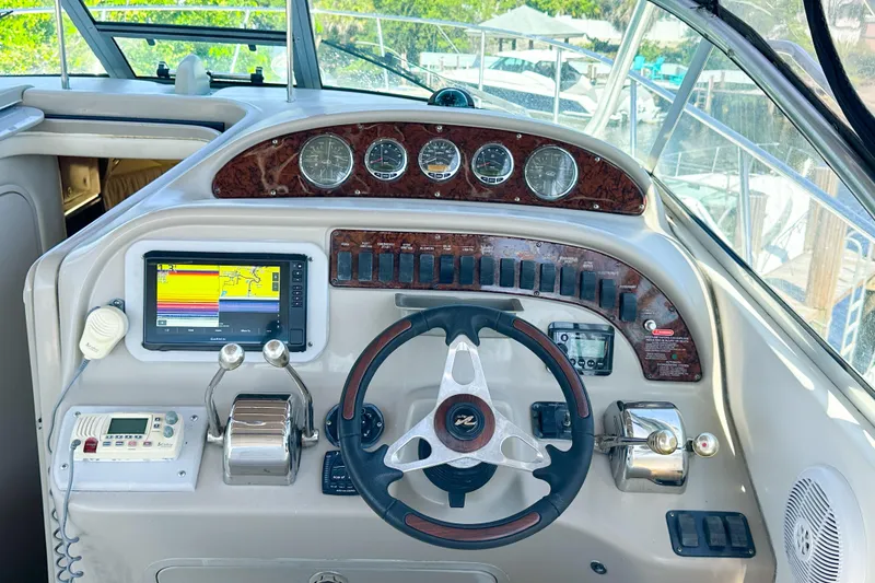 Slide: The Image of Cockpit of 2006 Sea Ray 290 Amberjack with steering wheel and navigation instruments. - 8