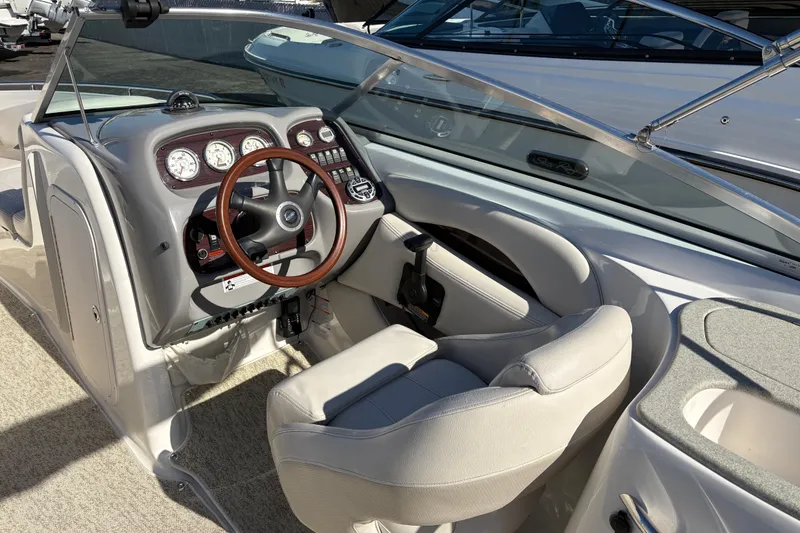 Slide: The Image of 2004 Chaparral 256 SSi boat interior with steering wheel and dashboard controls. - 10
