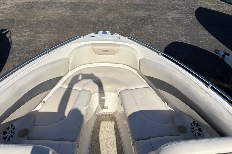 Slide: The Image of 2004 Chaparral 256 SSi boat interior with white seating and cup holders. - 3