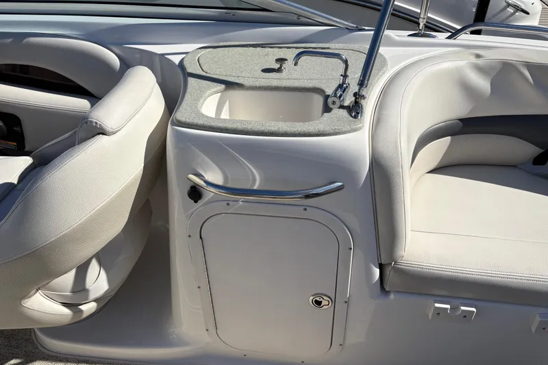 Slide: The Image of 2004 Chaparral 256 SSi boat interior with sink and seating area. - 9