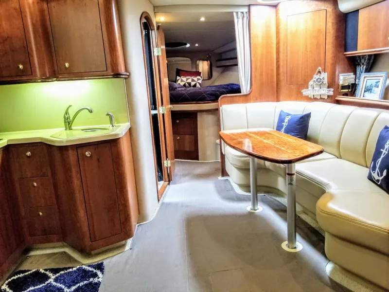 Slide: The Image of Interior of 2000 Cruisers Yachts 3672 Express with kitchen and seating area. - 10