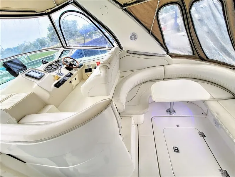 Slide: The Image of Interior of a 2000 Cruisers Yachts 3672 Express, luxurious white seating area. - 12