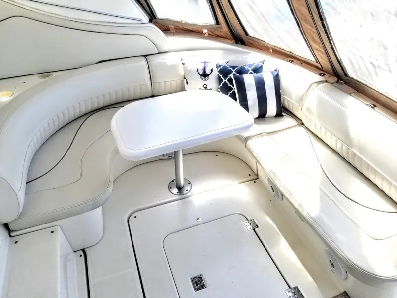 Slide: The Image of Interior of 2000 Cruisers Yachts 3672 Express with white seating area. - 13