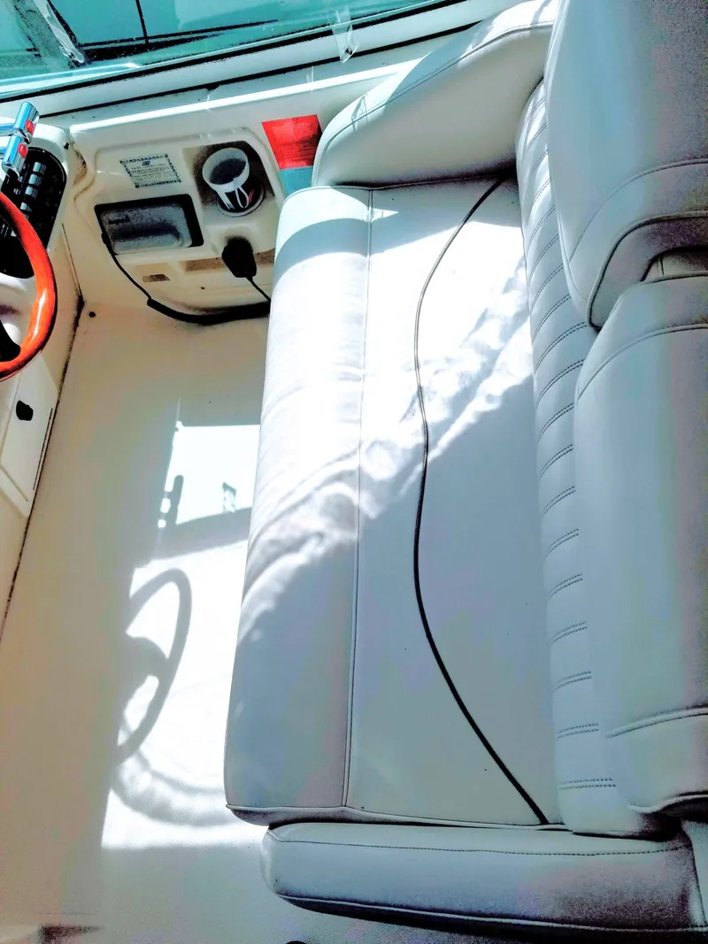 Slide: The Image of Interior of a 2000 Cruisers Yachts 3672 Express with white seating. - 16