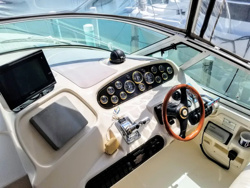 Slide: The Image of 2000 Cruisers Yachts 3672 Express cockpit with steering wheel and instruments. - 17