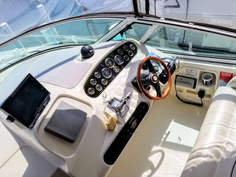 Slide: The Image of 2000 Cruisers Yachts 3672 Express cockpit with steering wheel and instruments. - 18