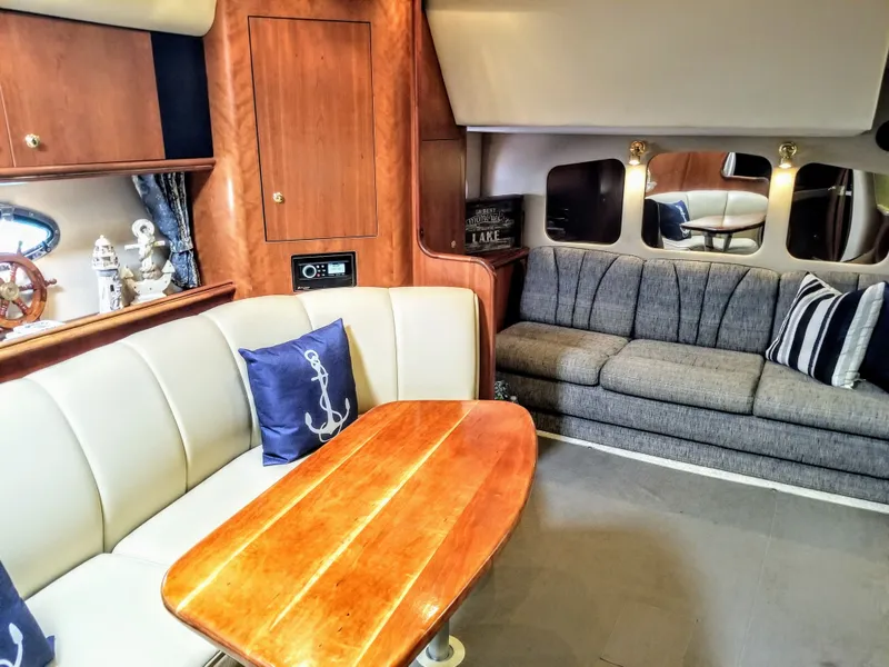 Slide: The Image of Interior of a 2000 Cruisers Yachts 3672 Express, featuring elegant seating area. - 27