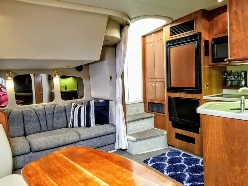 Slide: The Image of Interior of 2000 Cruisers Yachts 3672 Express with sofa and kitchen. - 3