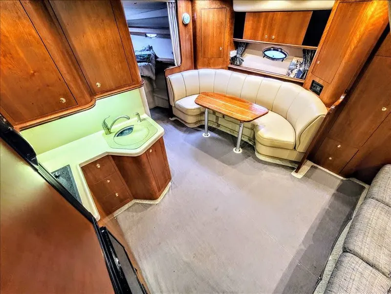 Slide: The Image of Interior of 2000 Cruisers Yachts 3672 Express with kitchen and seating area. - 31
