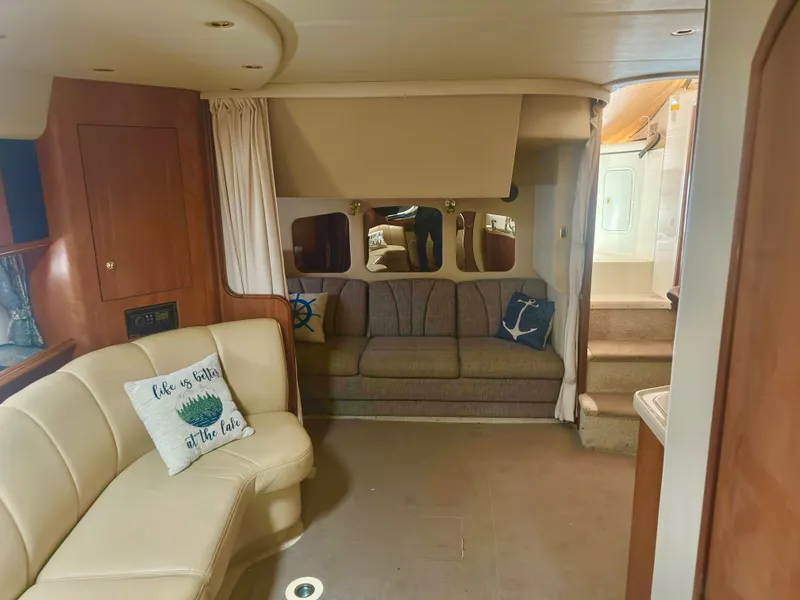 Slide: The Image of Interior of 2000 Cruisers Yachts 3672 Express with sofa and cushions. - 32