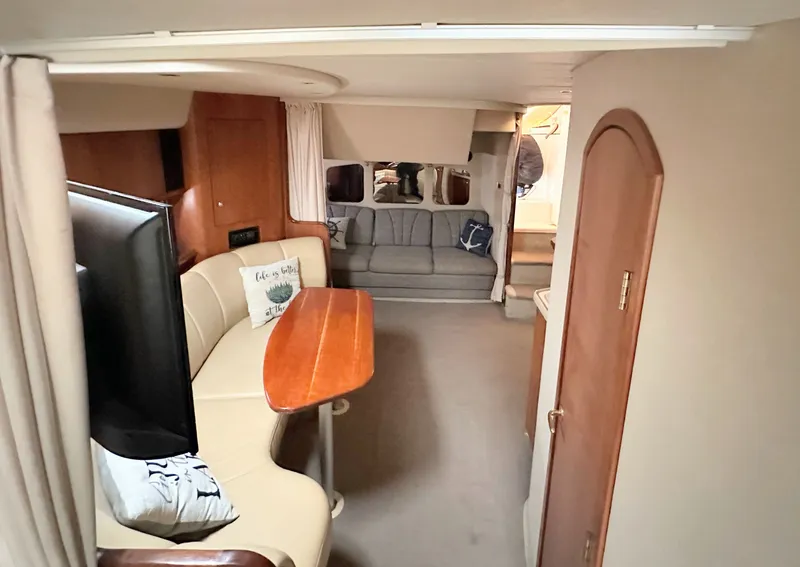 Slide: The Image of Interior of 2000 Cruisers Yachts 3672 Express with sofa and dining table. - 33