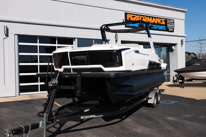 Slide: The Image of 2025 Balise Helix 24C boat on trailer at Performance Marine Sports dealership. - 11