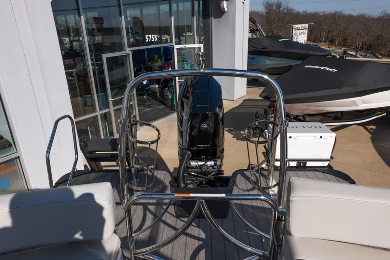 Slide: The Image of 2025 Balise Helix 24C boat with Verado engine, displayed outside a showroom. - 13