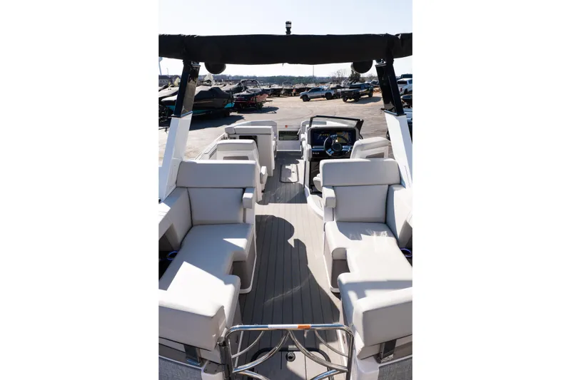 Slide: The Image of 2025 Balise Helix 24C boat interior with plush seating and modern helm. - 16